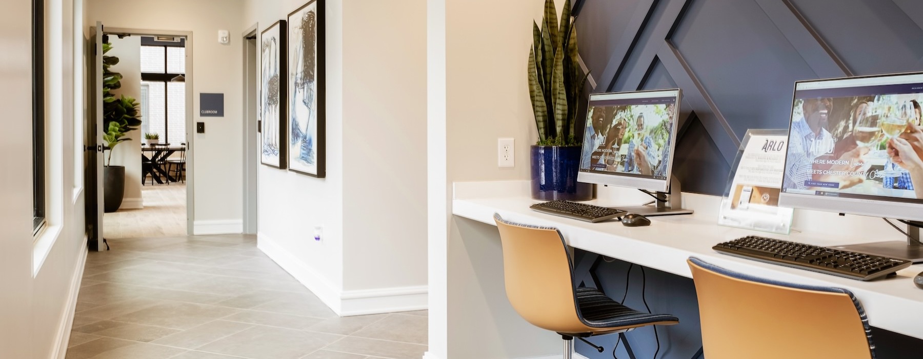 a room with a desk and computers